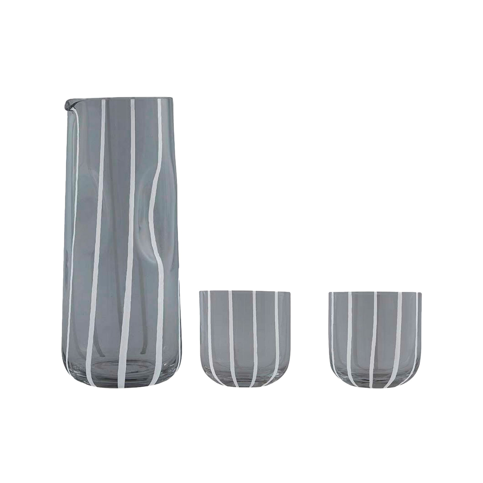 Mizu Pitcher and Tumblers Set in mouth-blown striped glass with one tall pitcher and two matching tumblers on a table.