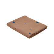 OYOY Nori Tablecloth in terracotta with scattered optic-blue dots, 100% organic cotton, available in two sizes.