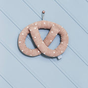 OYOY Sweet Pretzel Cushion in caramel cotton knit with dotted design, cuddly pretzel pillow for kids or adults.