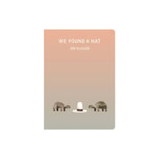 Cover of We Found a Hat by Jon Klassen featuring two turtles in a desert landscape looking at a single wide-brimmed hat, illustrated in his signature minimalist style.