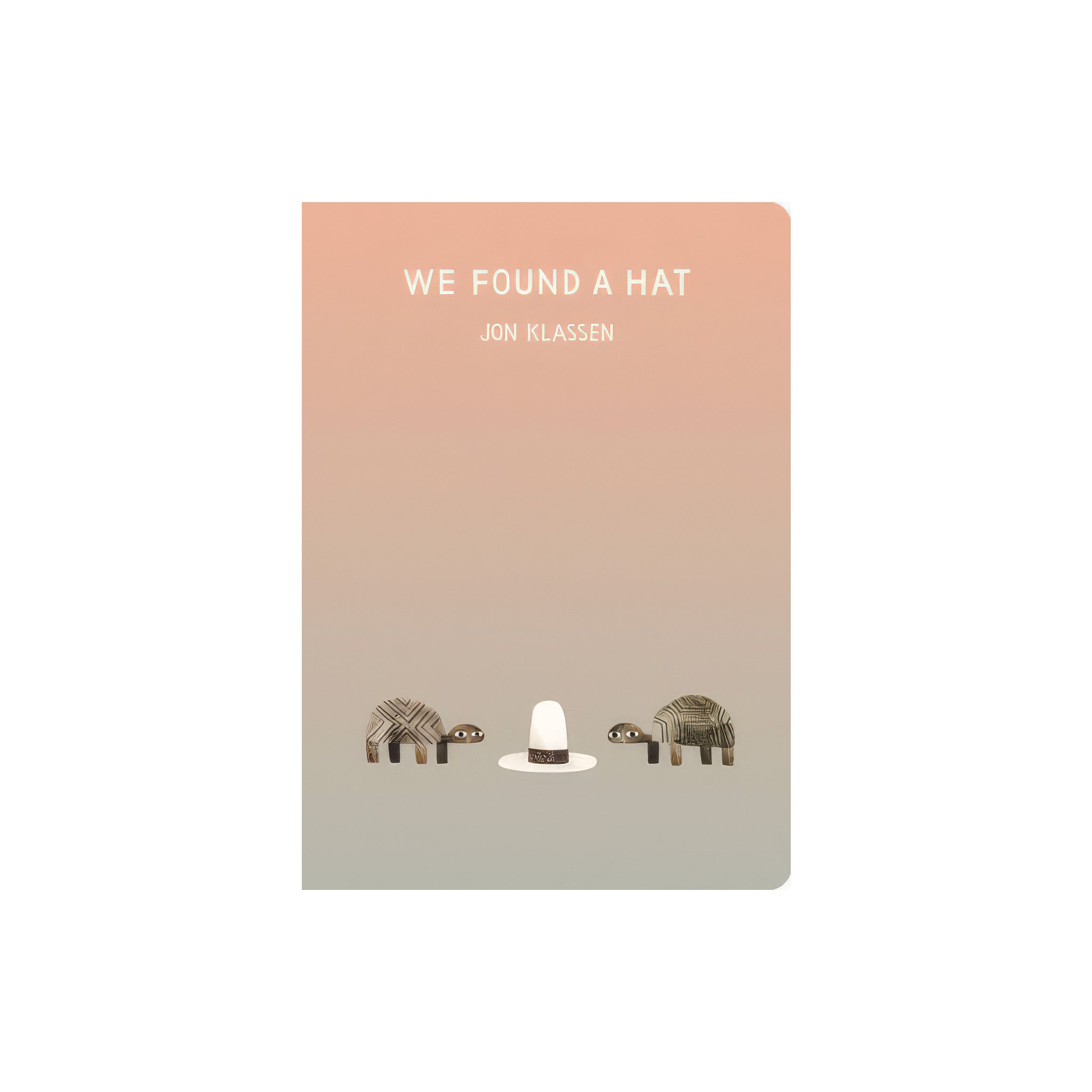 Cover of We Found a Hat by Jon Klassen featuring two turtles in a desert landscape looking at a single wide-brimmed hat, illustrated in his signature minimalist style.