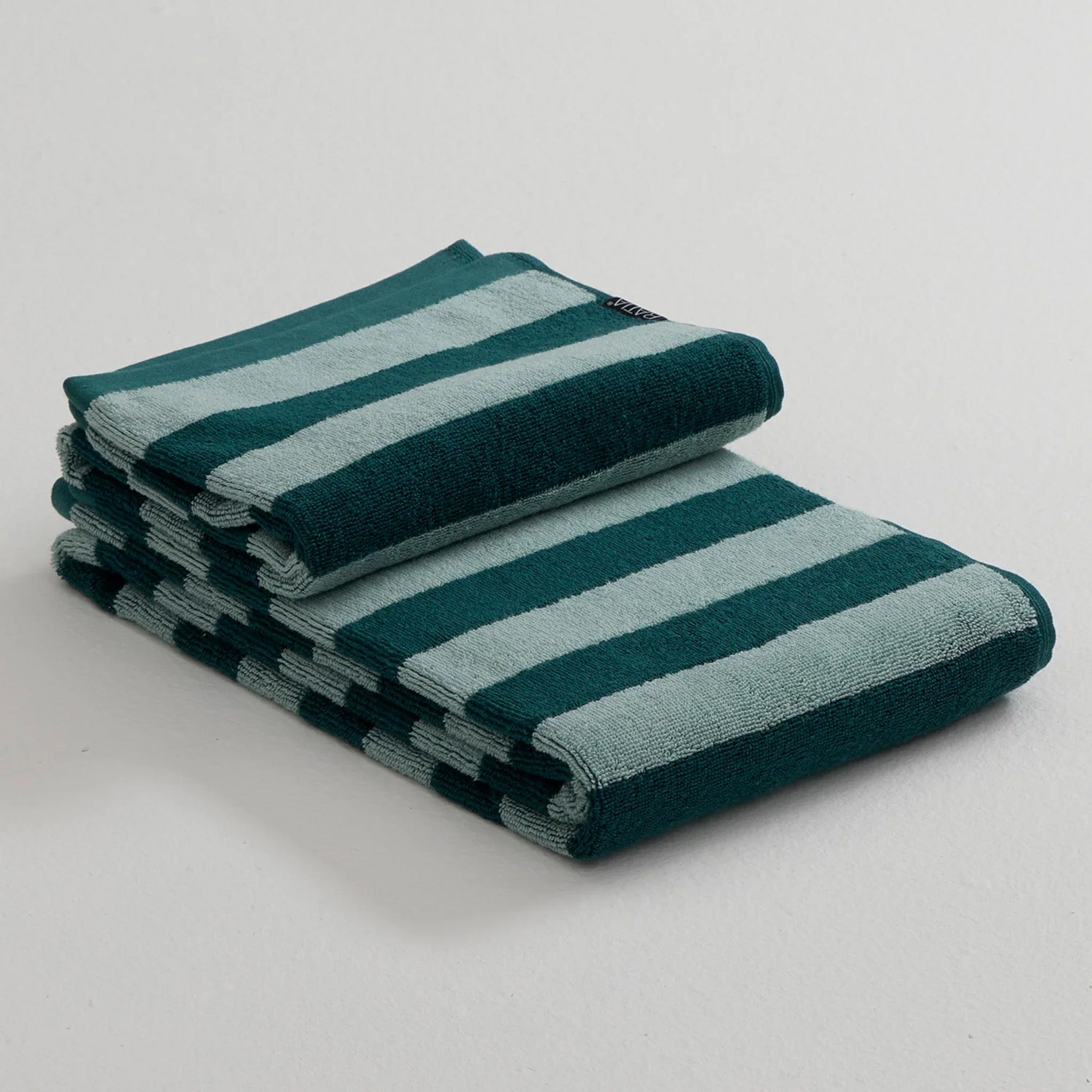 Stripe Towel by RATIA in tonal blue or green stripes, made from 100% cotton.