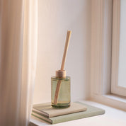 Skandinavisk Fjord 200ml scent diffuser in painted glass bottle with wooden ring and reeds.