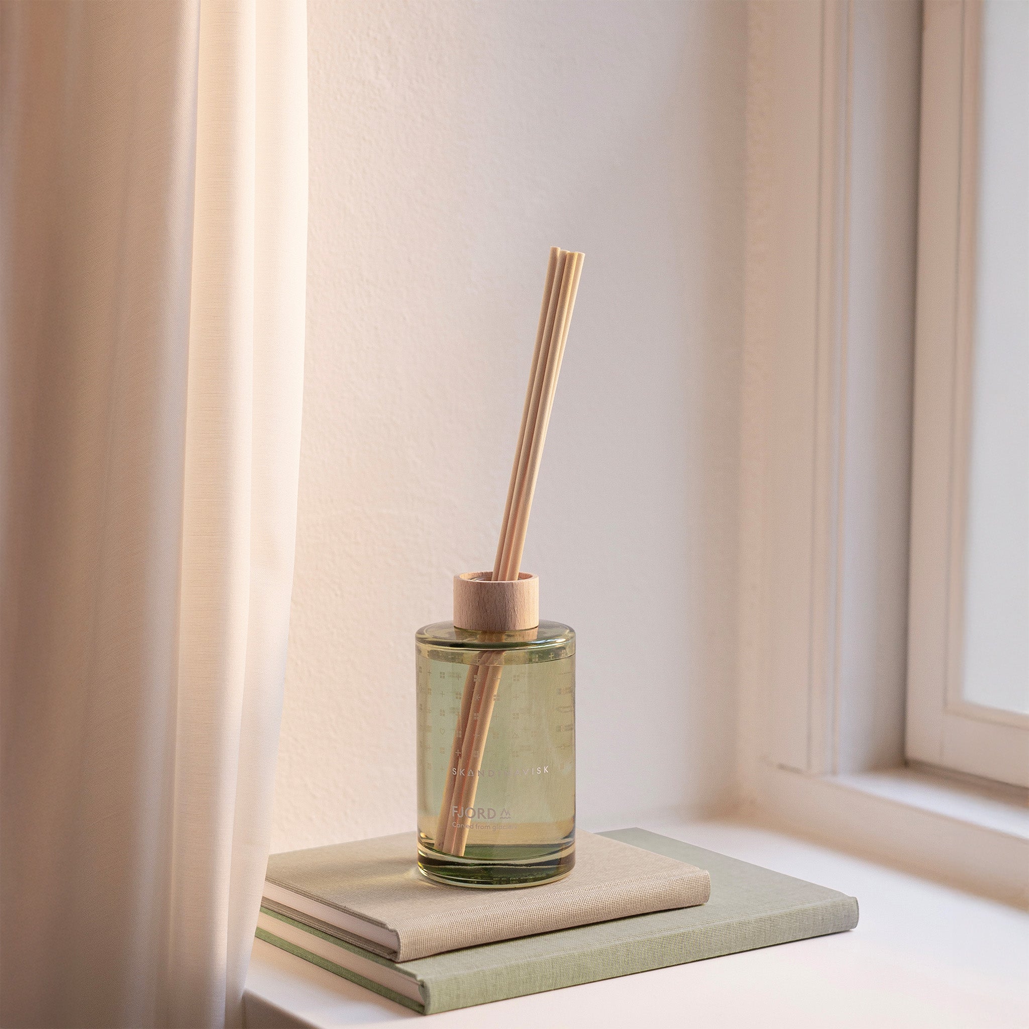 Skandinavisk Fjord 200ml scent diffuser in painted glass bottle with wooden ring and reeds.