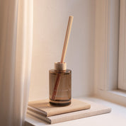Skandinavisk Hygge 200ml scent diffuser in painted glass bottle with wooden ring and reeds.