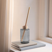 Skandinavisk Øy 200ml scent diffuser in painted glass bottle with wooden ring and reeds.