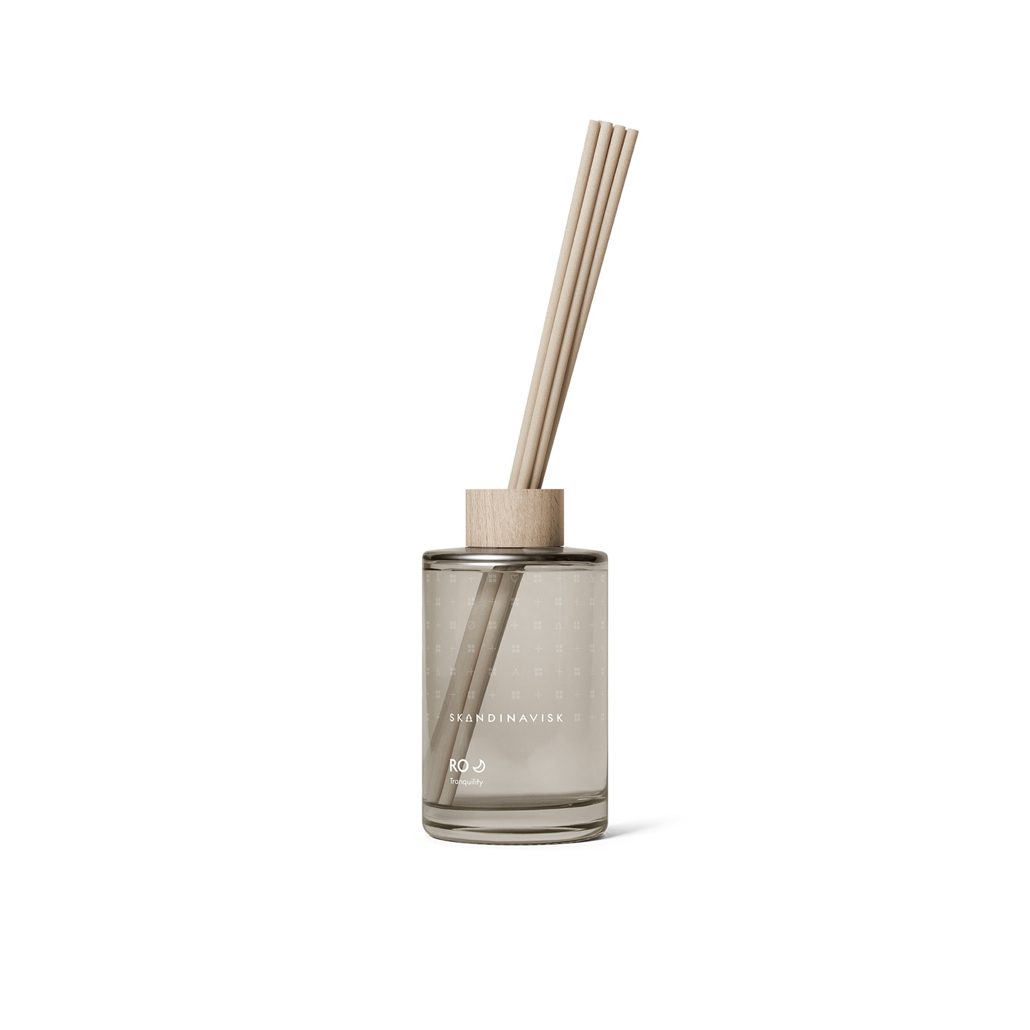 Ro Scent Diffuser by Skandinavisk with Scandinavian-inspired fragrance notes of cut grass, cucumber, wild violets, and fallen leaves in a minimalist glass diffuser vessel.