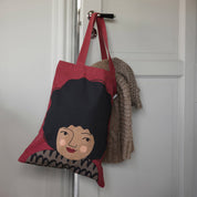 Spira of Sweden Hedvig Kompiskasse Tote Bag in deep red cotton with hand-printed Hedvig illustration and black hair.