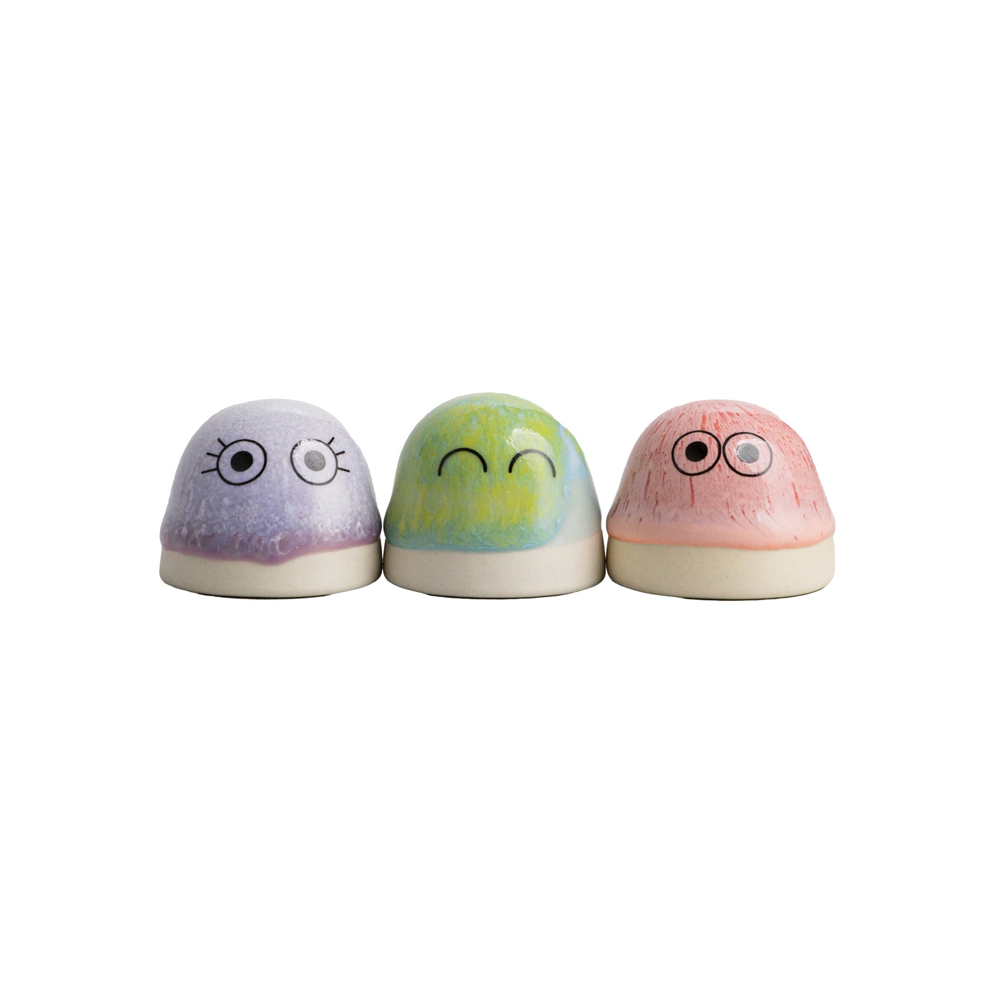 Dot by Studio Arhoj handmade porcelain figurines in purple, green, and pink glazes with expressive eyes.