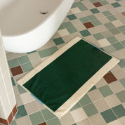 Aqua Dark Green Bath Mat by SUITE702 in aqua, dark green and cream with a reversible graphic design.