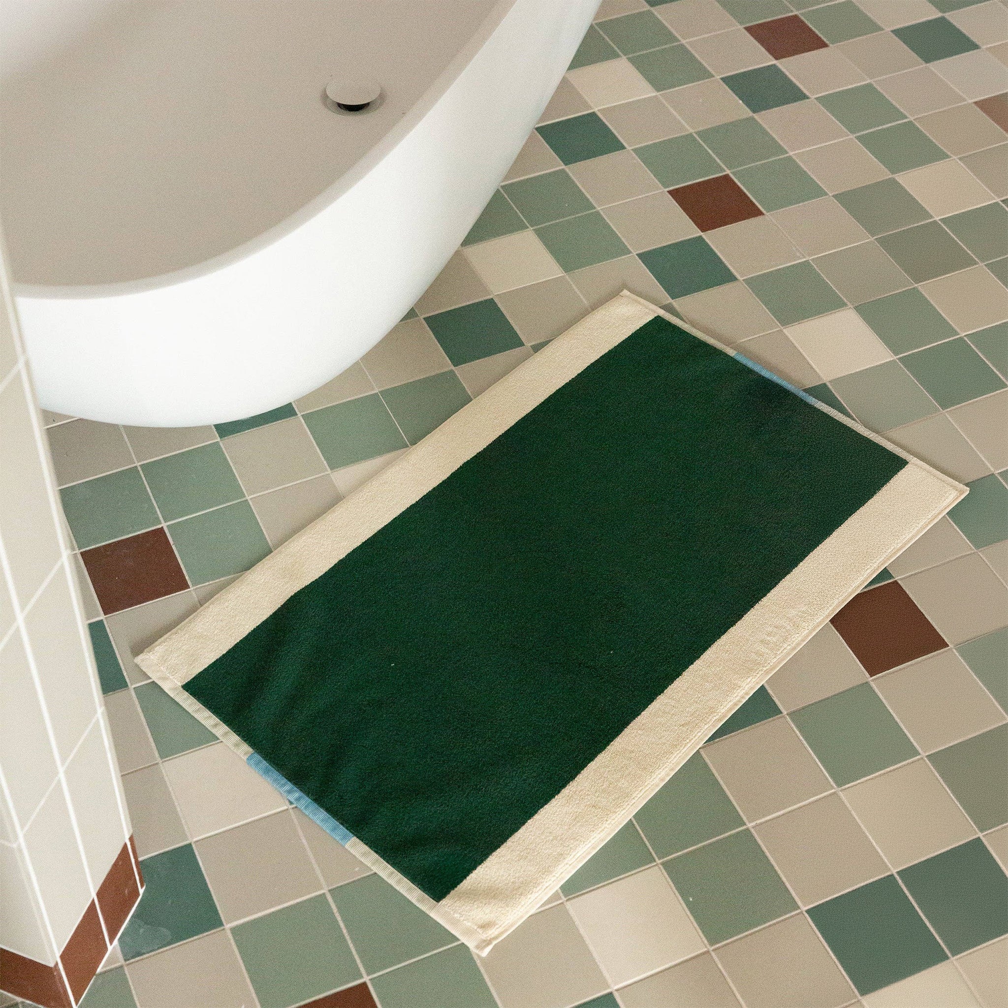 Aqua Dark Green Bath Mat by SUITE702 in aqua, dark green and cream with a reversible graphic design.