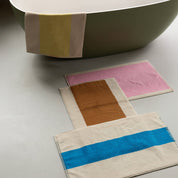Toffee Turquoise Bath Mat by SUITE702 iwith a reversible graphic design.