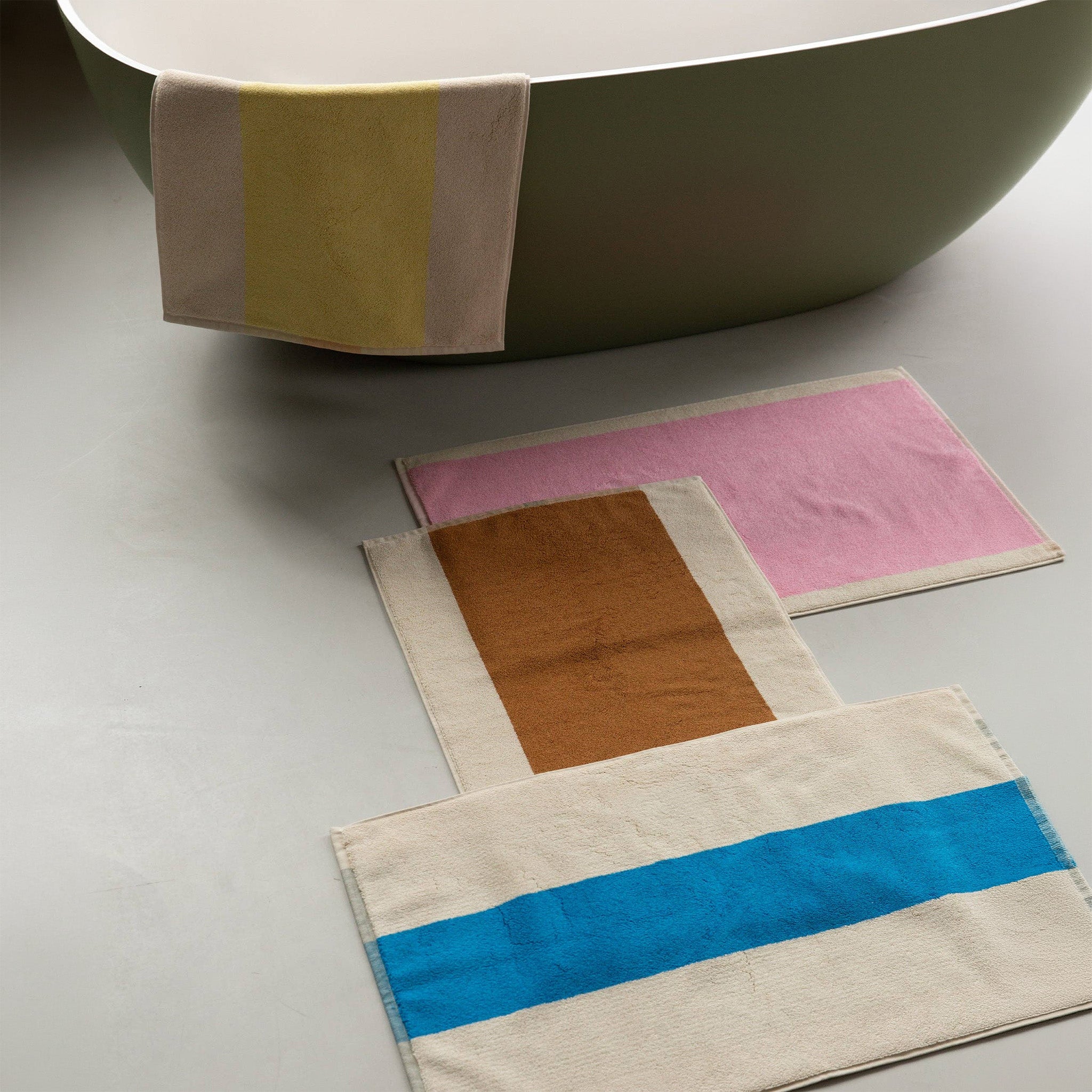 Toffee Turquoise Bath Mat by SUITE702 iwith a reversible graphic design.