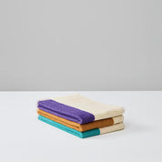Turquoise Purple Toffee Guest Towel Set by SUITE702 with three reversible colorful guest towels.