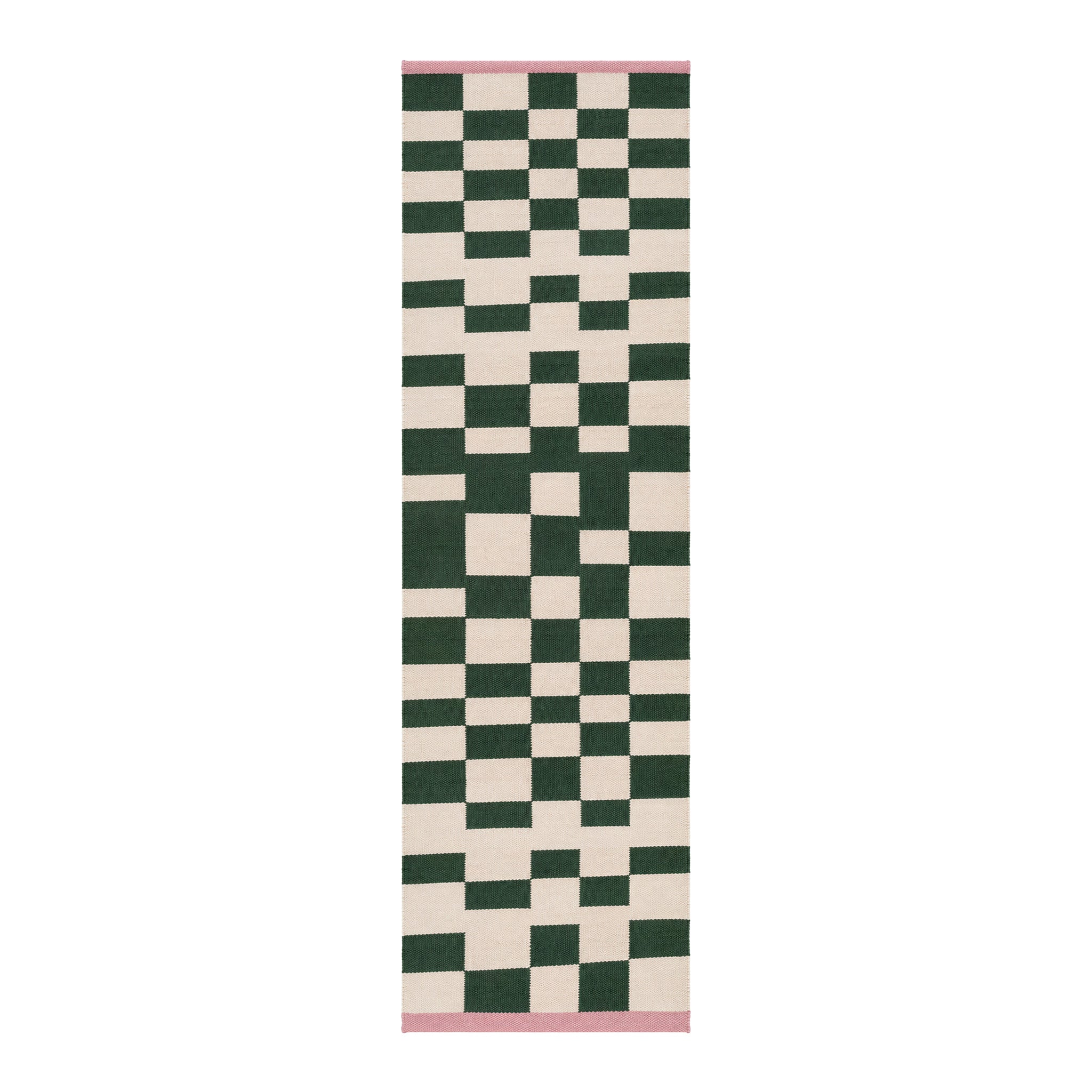 Blox Rug by Tarta Gelatina in Rosin, featuring an irregular forest green and cream checkerboard pattern with soft pink trim at both ends. Handmade from 100% cotton.
