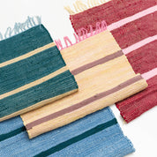 Upcycled Rug by Tarta Gelatina with colorful woven stripes and fringed ends, designed in Barcelona and handmade from upcycled cotton textiles.