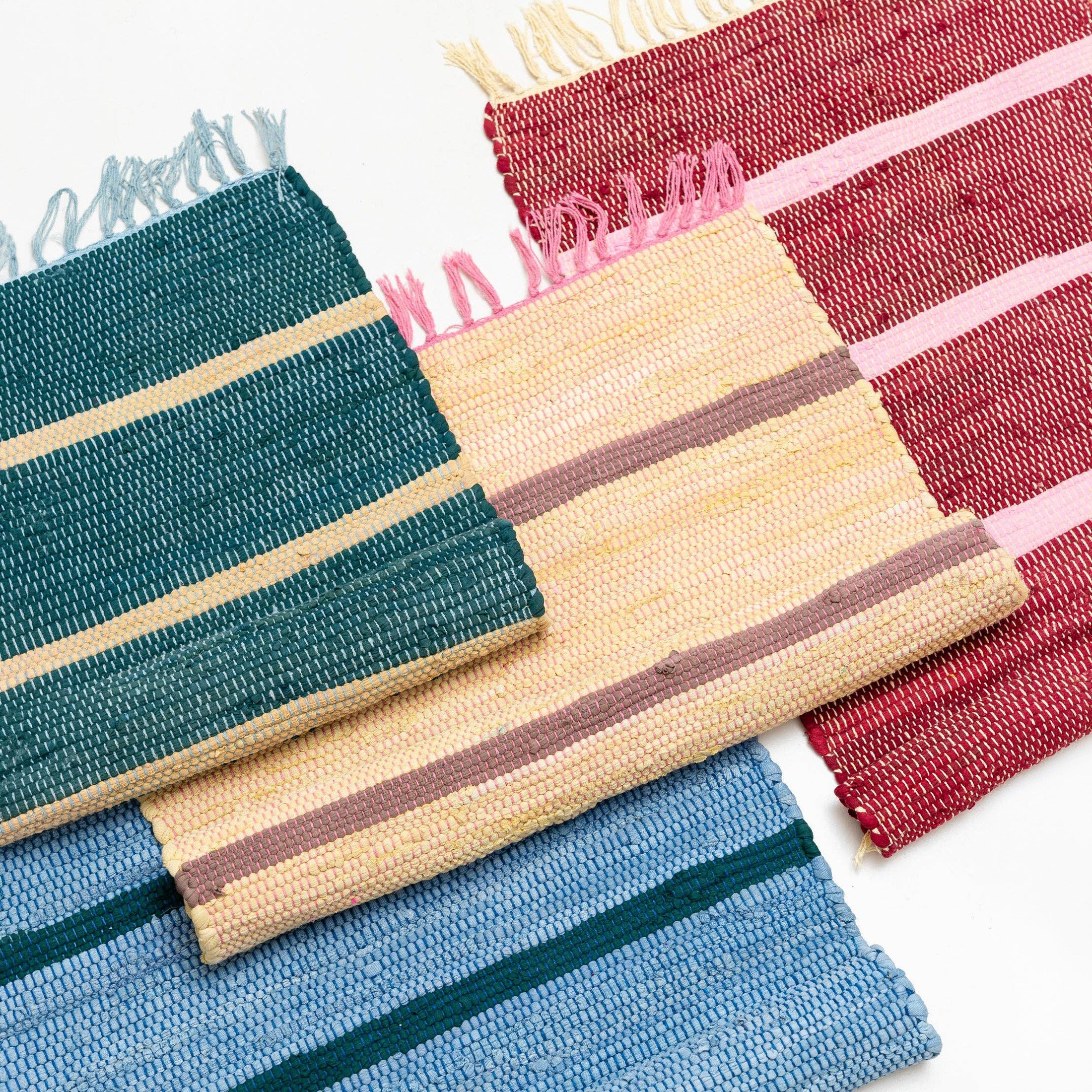 Upcycled Rug by Tarta Gelatina with colorful woven stripes and fringed ends, designed in Barcelona and handmade from upcycled cotton textiles.