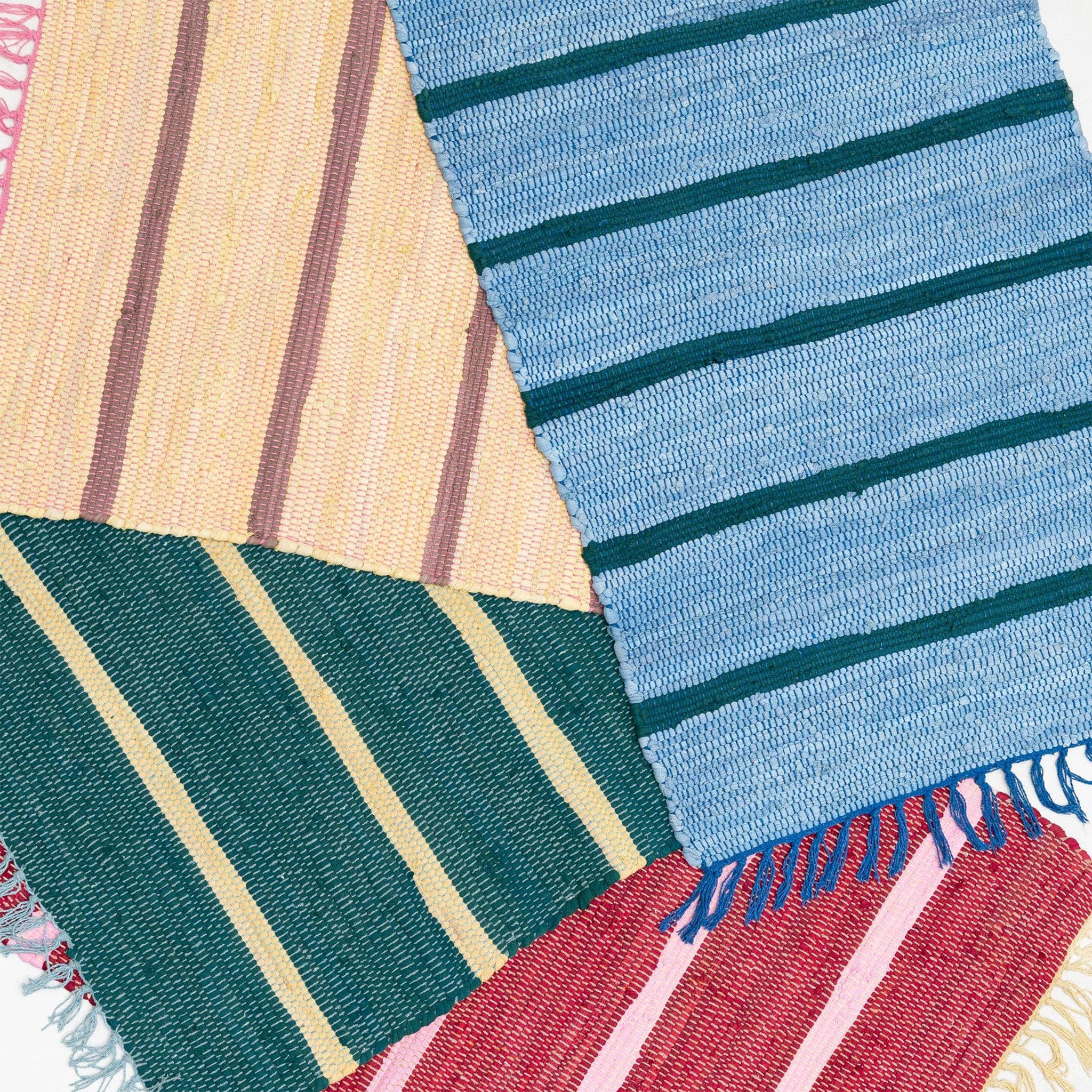 Upcycled Rug by Tarta Gelatina with colorful woven stripes and fringed ends, designed in Barcelona and handmade from upcycled cotton textiles.