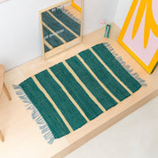 Upcycled Rug by Tarta Gelatina with colorful woven stripes and fringed ends, designed in Barcelona and handmade from upcycled cotton textiles.