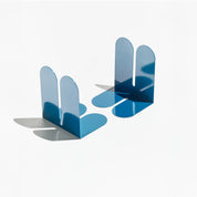 Tortuga Forma Large Bookend in abyss blue solid steel, oversized arc design for supporting heavy art books, cookbooks, and vinyl.