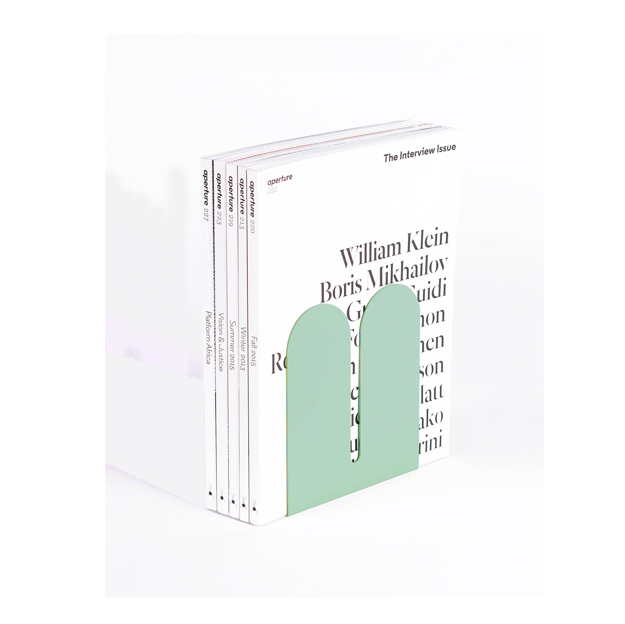 Tortuga Forma Large Bookend in cactus green solid steel, oversized arc design for supporting art books, cookbooks, or vinyl.