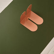Tortuga Forma Coral Bookend, solid steel arc design for holding cookbooks, magazines, and novels.