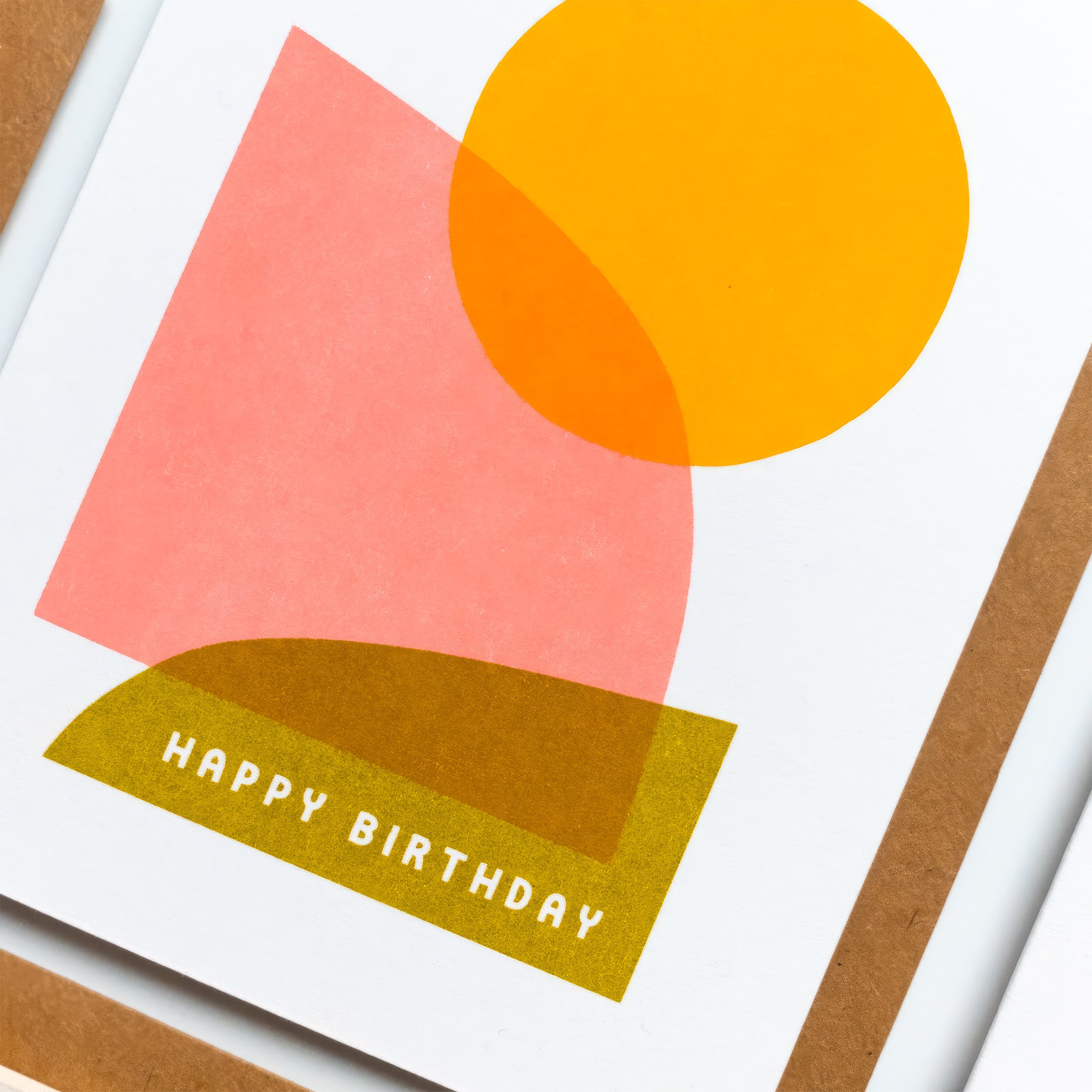 Birthday Hills Card with abstract pink, yellow, and olive green geometric shapes and a bright sun on a white background.