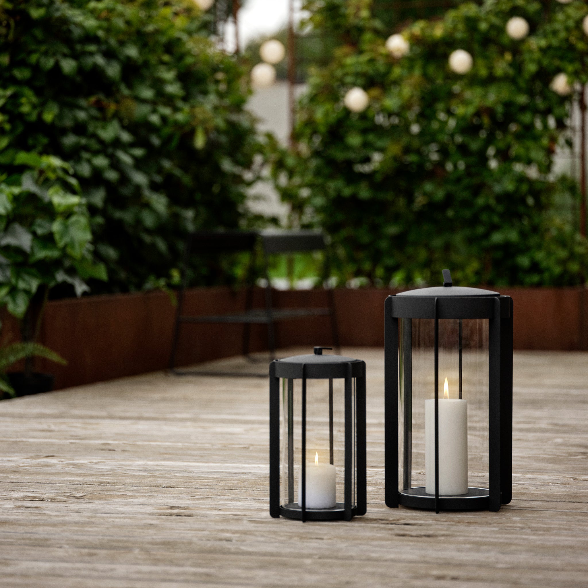 Firefly Lantern in powder-coated steel with glass sides and silicone strap by Zone Denmark. Available in two sizes: 25 cm and 35 cm.