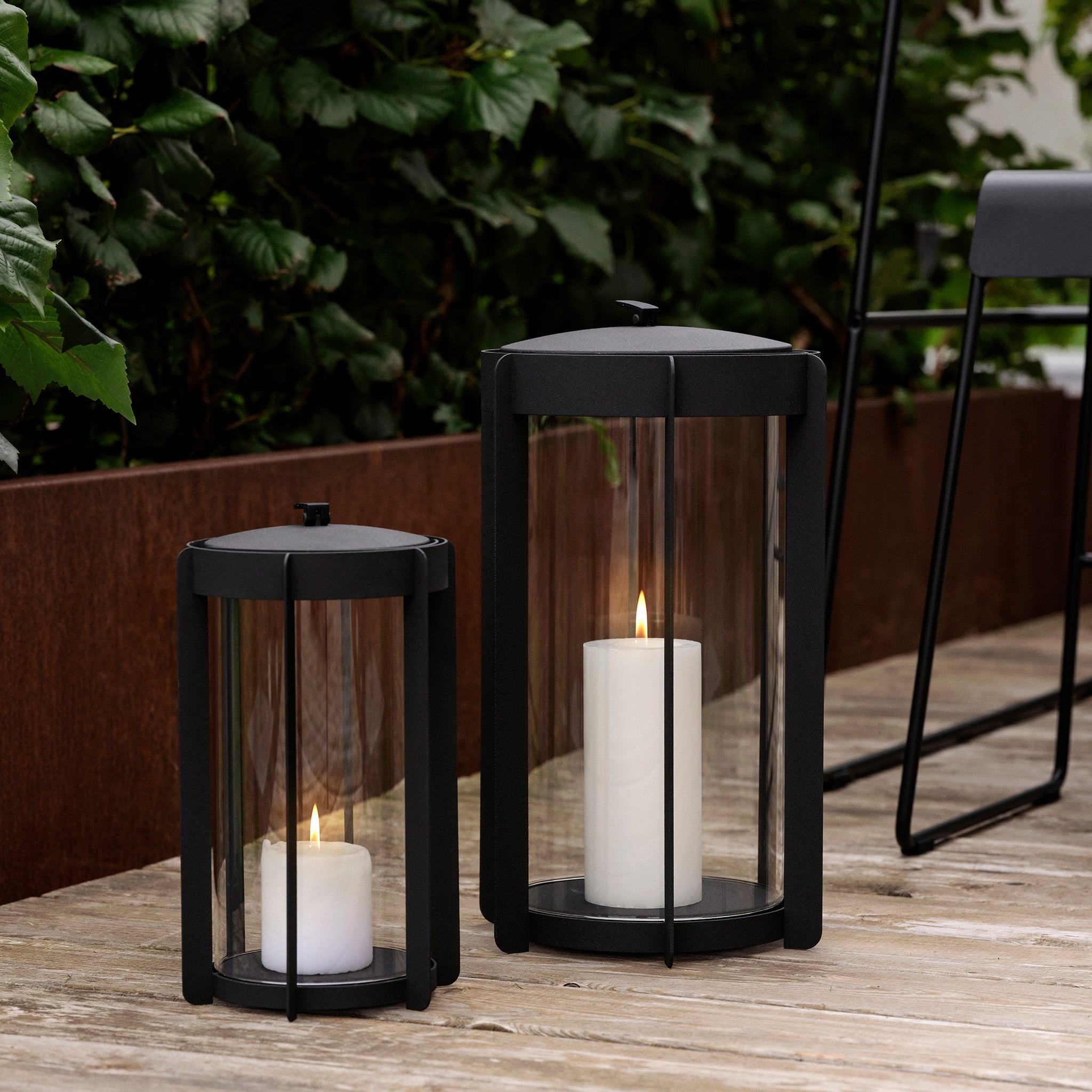 Firefly Lantern in powder-coated steel with glass sides and silicone strap by Zone Denmark. Available in two sizes: 25 cm and 35 cm.