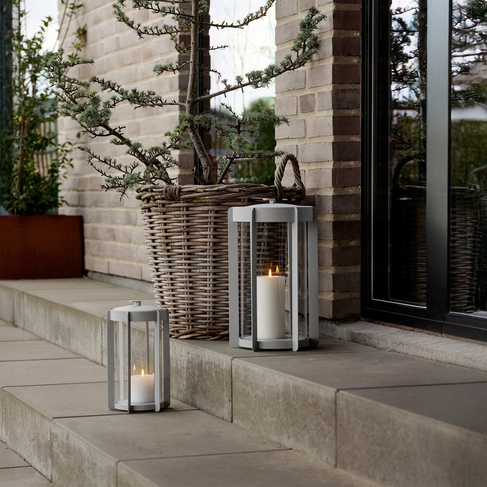 Firefly Lantern in powder-coated steel with glass sides and silicone strap by Zone Denmark. Available in two sizes: 25 cm and 35 cm.